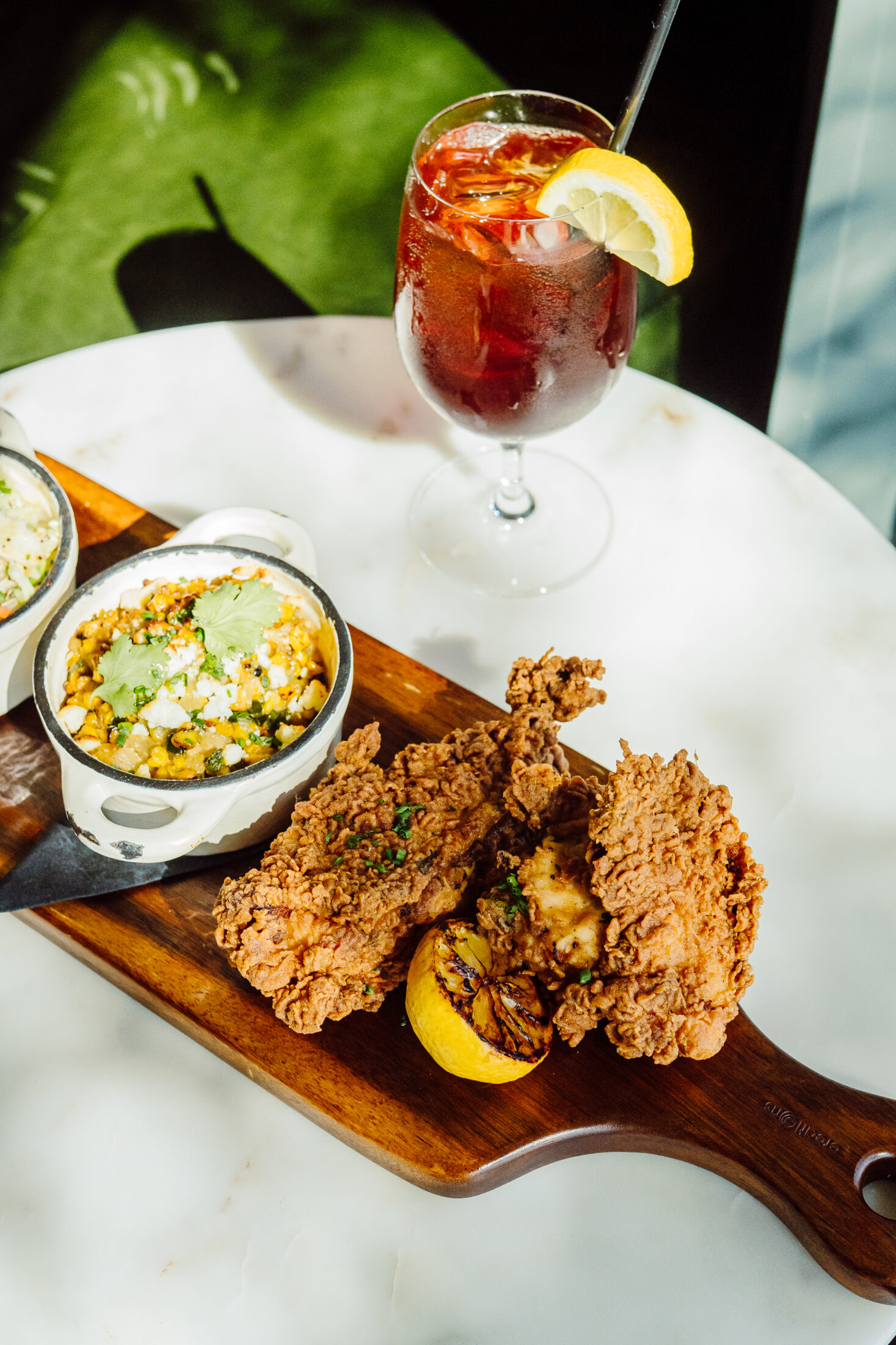 Plate of food on a table next to a drink