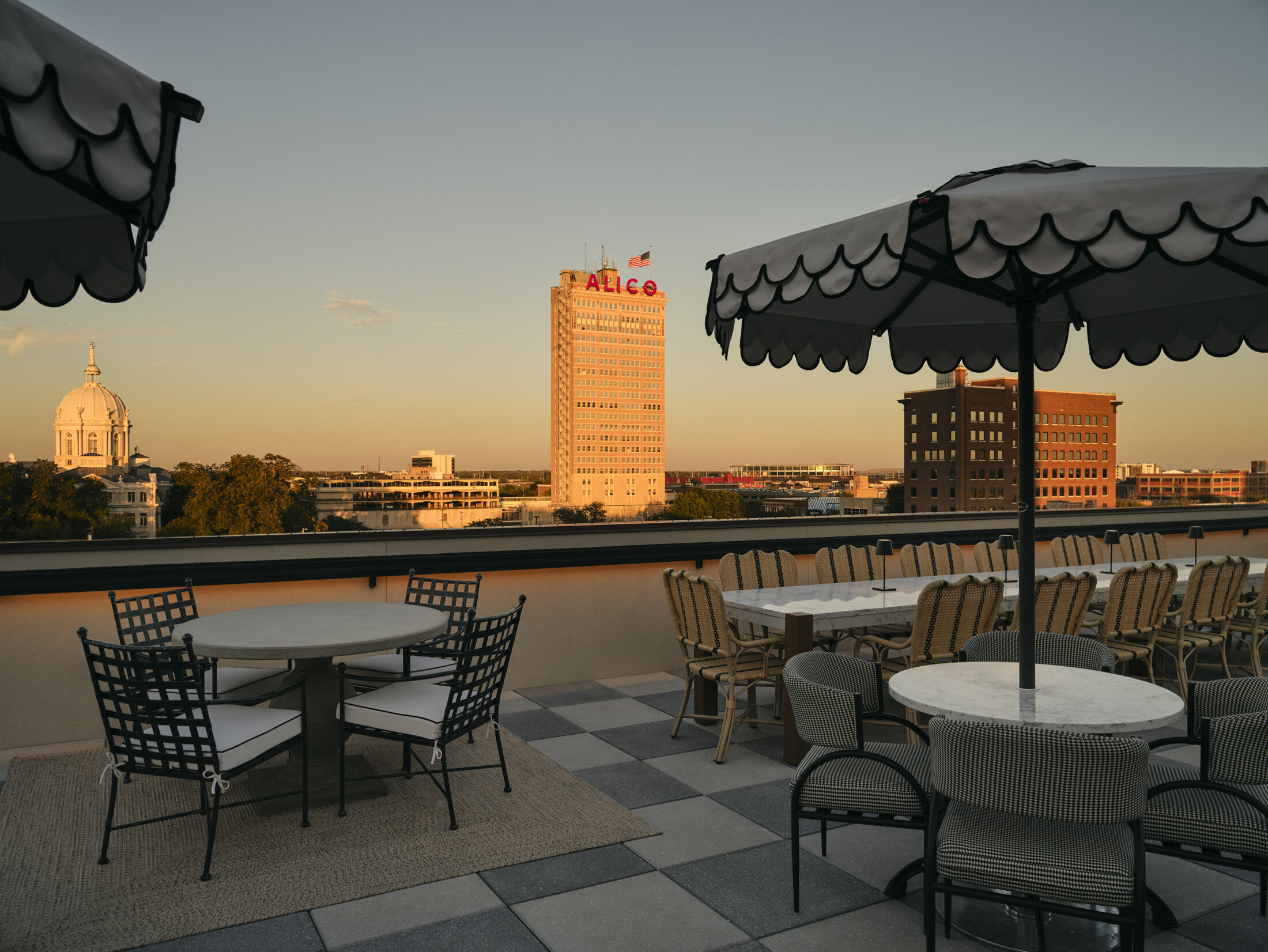 Rooftop dining area with seating and a view of Waco, Texas skyline