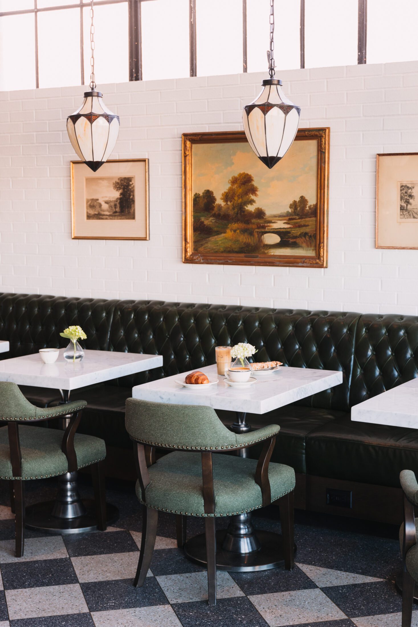 Restaurant tables with booth and art on the walls